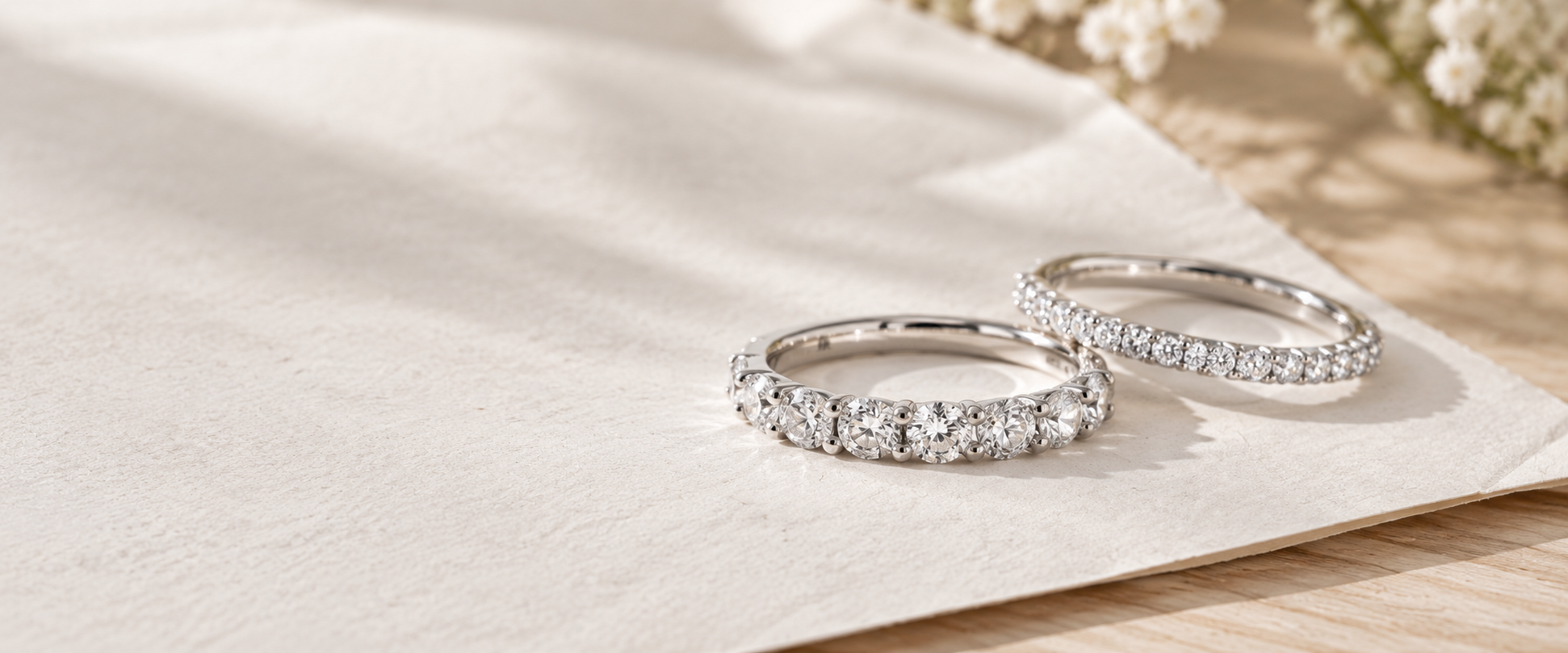 Two diamond eternity bands on soft ivory fabric